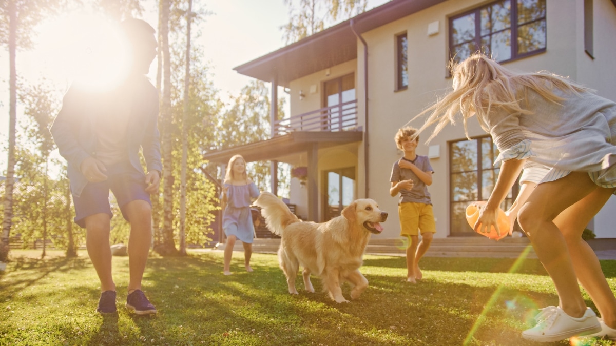 Family spending time outdoors with their dog after a thorough residential deep cleaning.