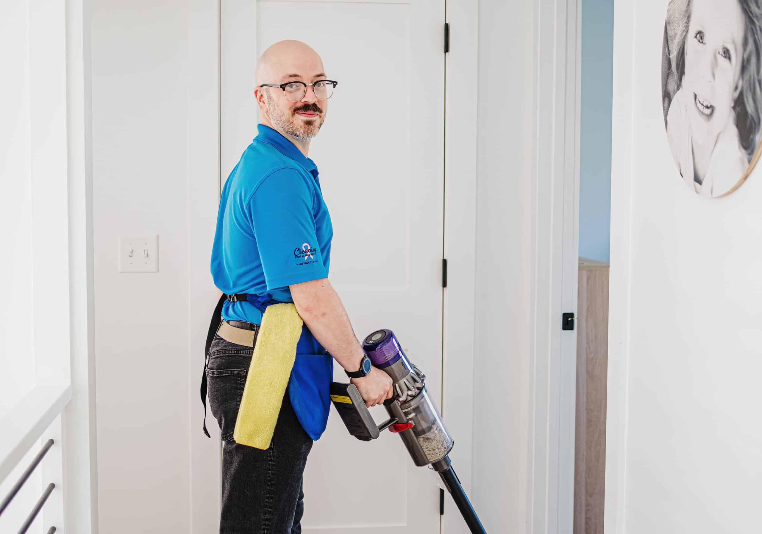 A Best Day Housecleaning cleaner vacuuming during a cleaning visit.